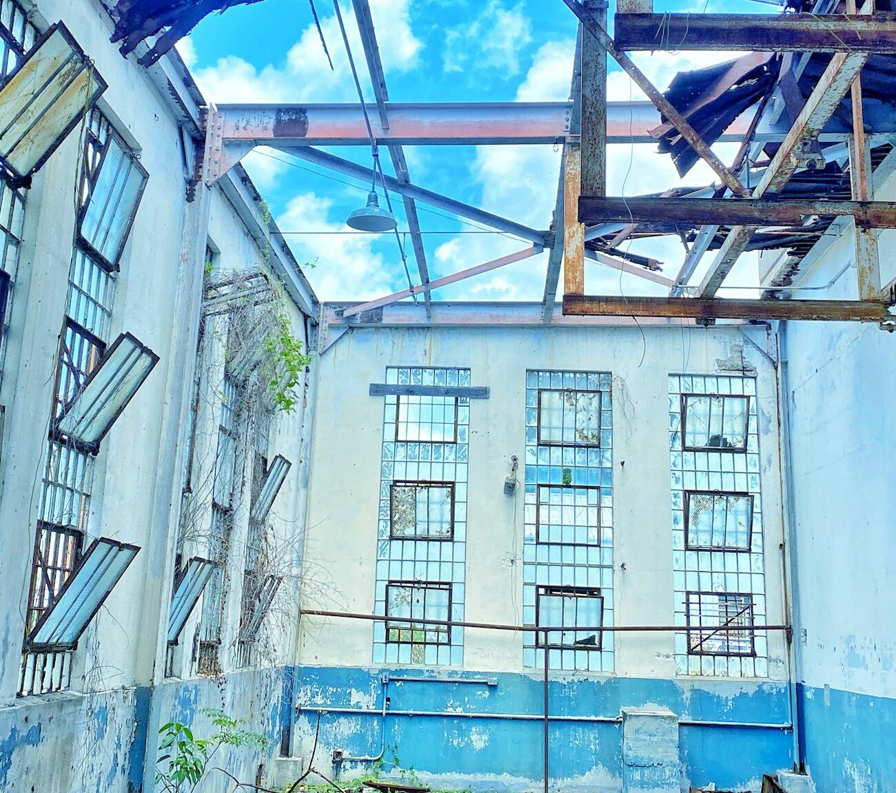 Hurricane damaged building blue sky puffy white cloud view